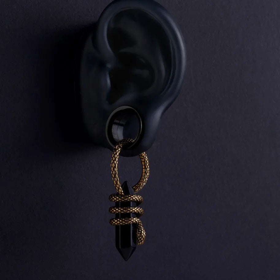 Koperen oorhanger gewicht Mystieke Slang, close-up.